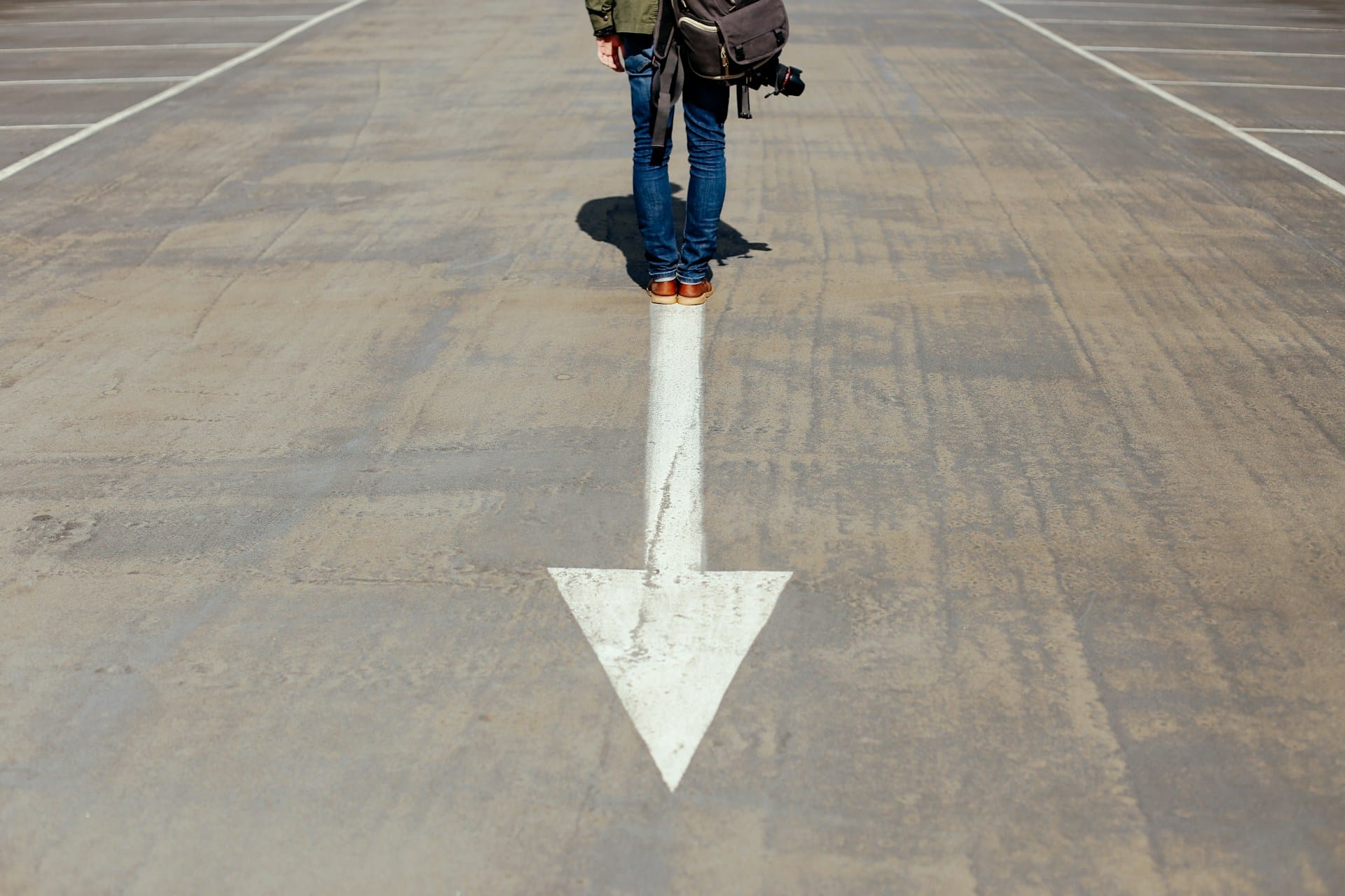 person standing on arrow sign